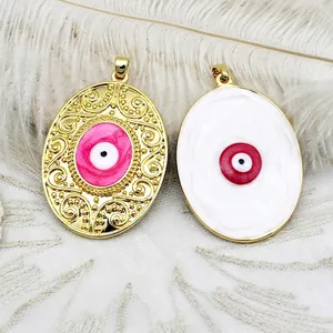 Double-sided oval evil eye pendant detail with pink and red enamel in gold plating
