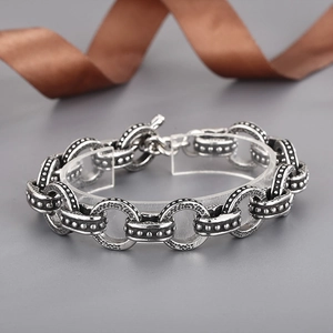 Detail of vintage silver toggle clasp bracelet with engraved interlocking oval links