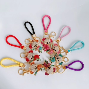 Top view of eight colorful koala keychains with rhinestones and woven leather wristlets