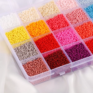 Close-up of glass seed bead set in a transparent multi-grid organizer for DIY jewelry