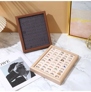 Detail view of walnut wood ring display tray with premium velvet lining and jewelry slots