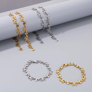 Detailed shot of titanium steel butterfly chain bracelets in gold and silver finishes