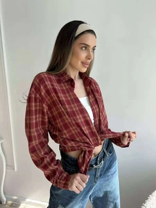 Dettaglio camicia a quadri rossa e gialla con trama in cotone e orlo annodato sul fondo