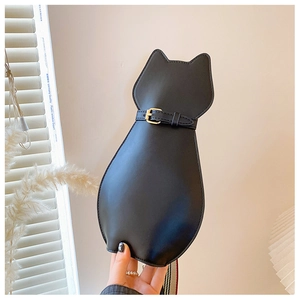Detailed shot of cat-shaped crossbody bag with decorative belt and striped strap