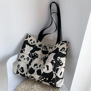 Detailed view of the cute panda print canvas tote bag with zipper and black straps