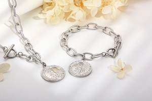 Detailed silver chain jewelry set with Miraculous Medal pendants and T-bar closures