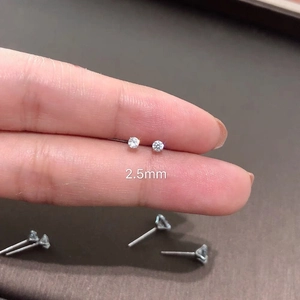 Macro shot of a 2.5mm cubic zirconia stud earring held to show the exact scale and detail