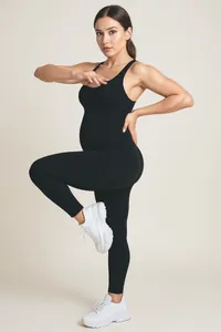 Detail of seamless black maternity jumpsuit with racerback design and high elasticity