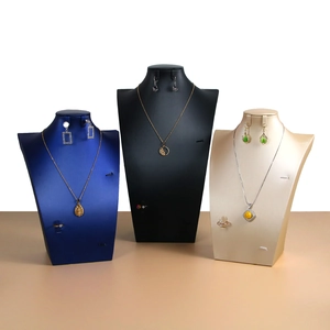 Three-piece jewelry bust set in blue, black, and gold for necklaces and earrings display