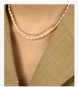Close-up of elegant double-layer necklace with freshwater pearls and gold bead chain