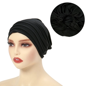 Detailed close-up showing the pleated sewing craftsmanship on a black stretch turban hat