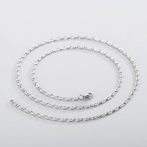 Macro detail of silver stainless steel spiral chain necklace with lobster clasp
