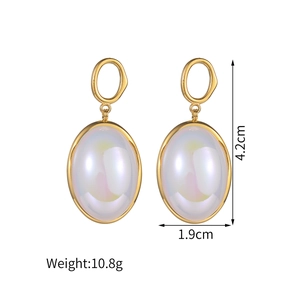 Detailed view of elegant gold oval earrings with pearl inlay showing size and weight specs
