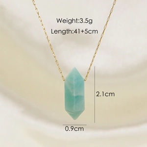 Macro shot of light blue hexagonal crystal pendant with gold chain and size markings