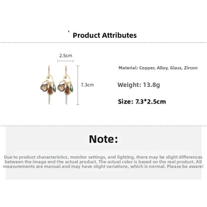 Macro detail of drop earrings with zirconia, glass beads, and precise dimensions