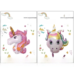 Set of large cartoon unicorn foil balloons in retail packaging for birthday party decor