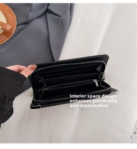 Detail of black long wallet interior with card slots and silver zipper coin compartment