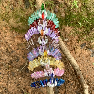 Natural crystal crown headbands with metal moons shown vertically on a wooden branch