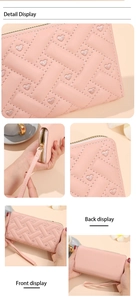 Macro detail of pink woven wallet with heart embroidery and golden metal zipper