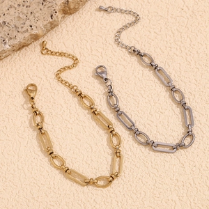 Minimalist 14K gold and silver stainless steel paperclip chain bracelets on stone