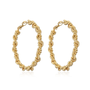 Detail of 18K gold-plated twisted hoop earrings with elegant woven texture on white background