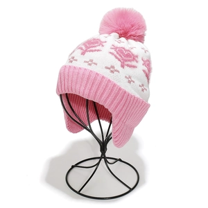 Pink and white knit kids winter hat with fleece lining, ear flaps and faux fur pom pom