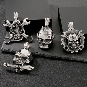 Detailed view of four silver punk skull pendants with mechanical wrenches and gear elements