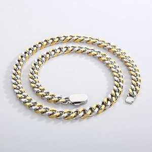 Macro detail of high-polished two-tone gold and silver Cuban link chain with sturdy clasp