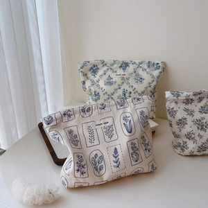 Three floral cotton drawstring pouches with simple wish label on a wooden display