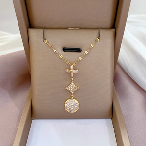 Titanium steel necklace with crystal-embedded floral and star pendants in a jewelry box
