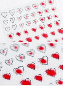 Detailed macro view of 5D nail art stickers with red gradient heart patterns