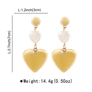 Detail view of heart-shaped drop earrings with gold finish and faux pearls showing dimensions