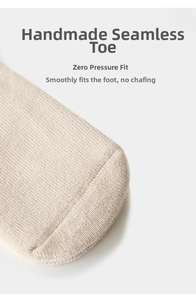 Detail of hand-linked seamless toe on beige knitted baby socks for smooth comfort