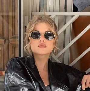 Trendy retro oval sunglasses with slim gold metal frame and dark lenses for street style