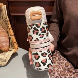 Detail showing leopard print thermal cup with a convenient press-button lid for daily use