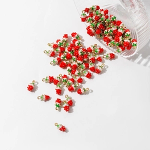 DIY red strawberry charms for jewelry making with gold-plated loops on white background