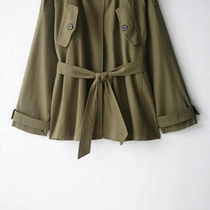 Olive green cotton trench coat with waist belt and twill fabric texture details