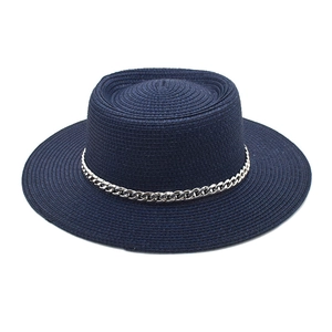 Close-up of deep blue straw boater hat featuring fine weave and silver metal chain trim