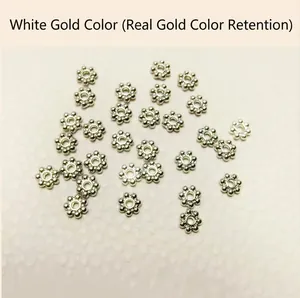 Detailed macro view of white gold plated snowflake beads for jewelry making DIY