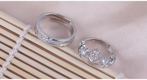 Detail of silver crown couple rings for prince and princess with sparkling zircon stones