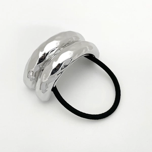 Close-up of a silver wavy metal texture accessory on a black high-elastic hair tie