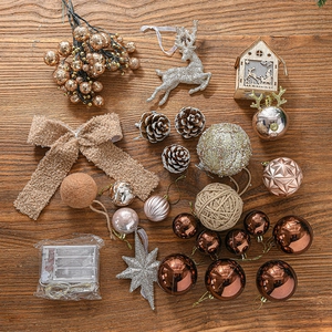 Assorted Christmas tree ornaments set with LED lights and glitter decor on dark wood