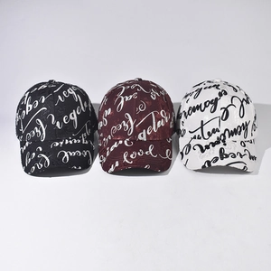 Unisex baseball caps with all-over script lettering in black, burgundy, and white colors