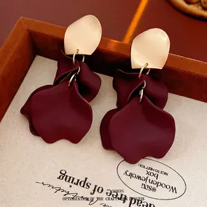 Vintage irregular gold leaf and deep red flower earrings in a rustic wooden display box
