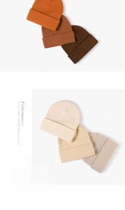 Close-up of double-layer knit beanies in various earth-tone colors and fine textures