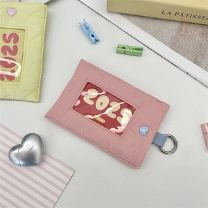 Detailed view of quilted heart card holders in pink and yellow with metal ring hook