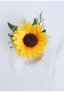 Detail of sunflower wrist corsage with white pearl bracelet and silk ribbon for weddings