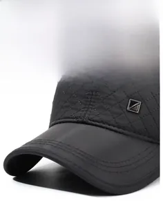 Close-up of winter baseball cap with diamond lattice stitching and metallic square emblem