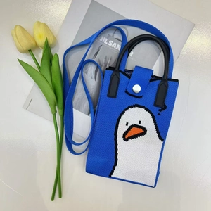 Detailed knit of a blue cartoon duck phone bag with shoulder strap and leather handles