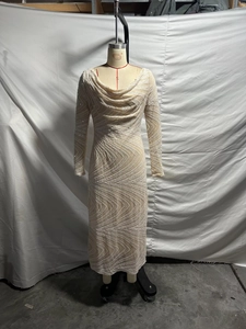 Detail of elegant sequined wave pattern on a beige slim fit evening dress with cowl neck